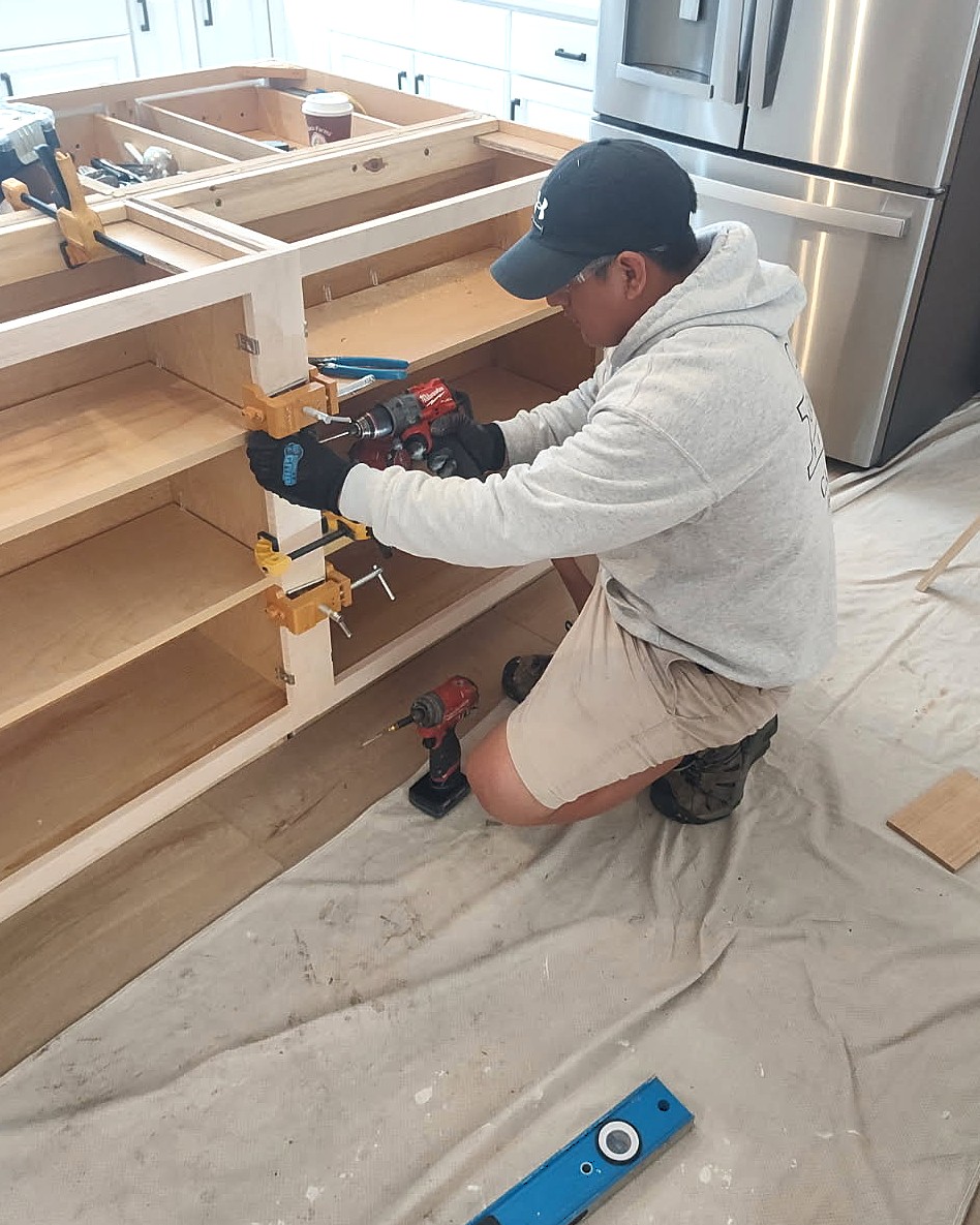 carpenter working on cabinets