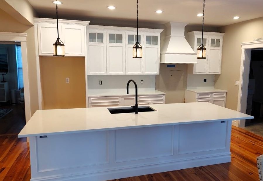 empty kitchen with newly painted cabinets and island