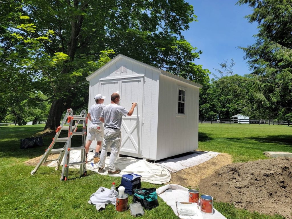 professional painters painting outdoor shed