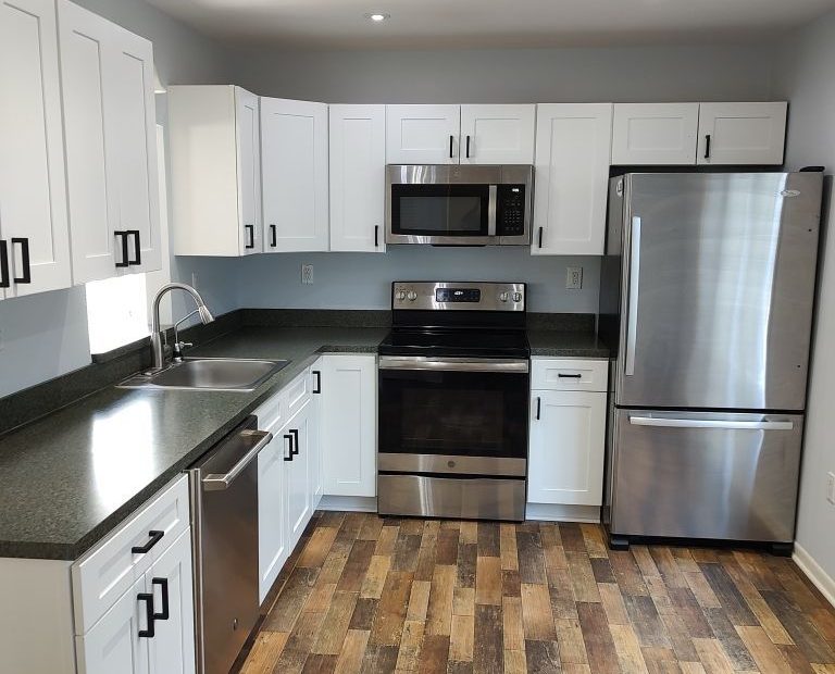kitchen with wooden floors and newly painter cabinets