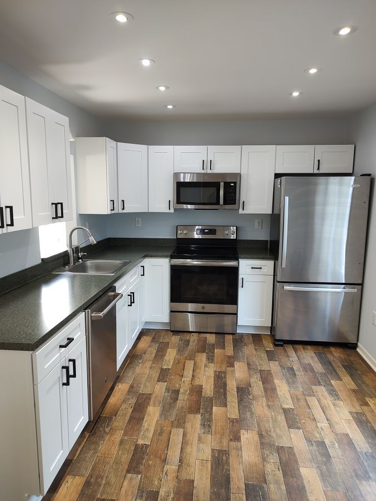 kitchen with wooden floors and newly painter cabinets